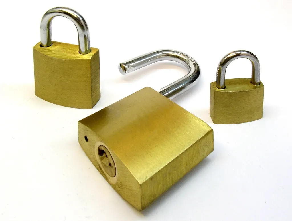 Three brass padlocks with one left open, a reminder to secure every server function