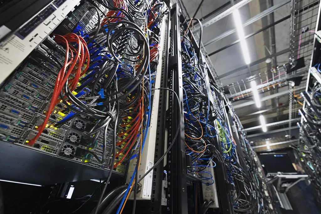 Server racks packed with cables and lights, where static UI can be rendered