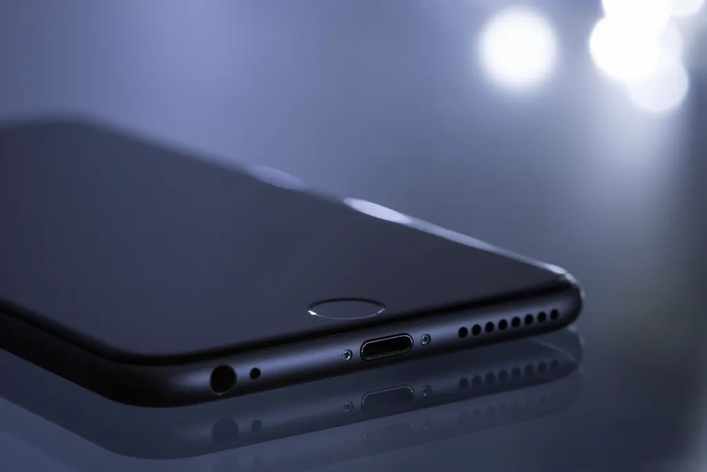 Black smartphone close-up with soft lights, where the hero image usually decides LCP