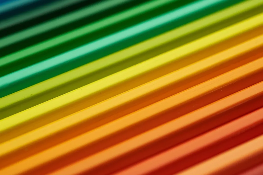 Rainbow of coloured pencils in a row, like design tokens defining a shared palette