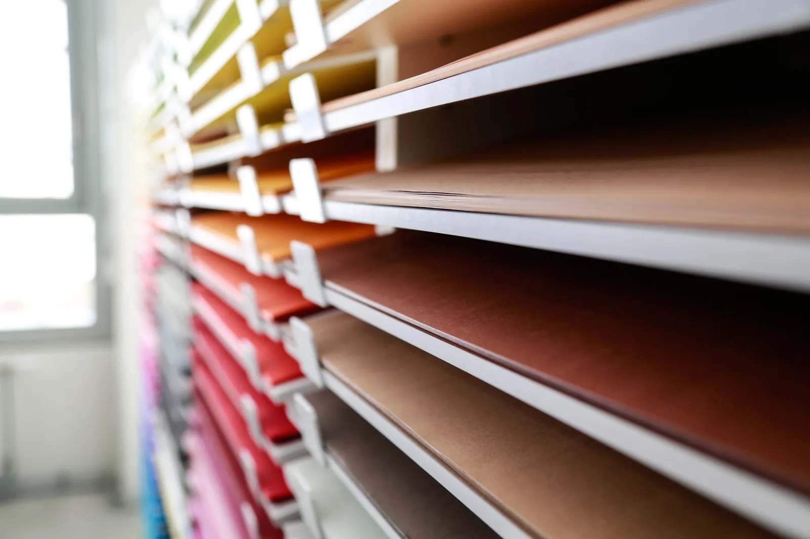 Shelves of coloured paper sorted into compartments, like component states shown one by one