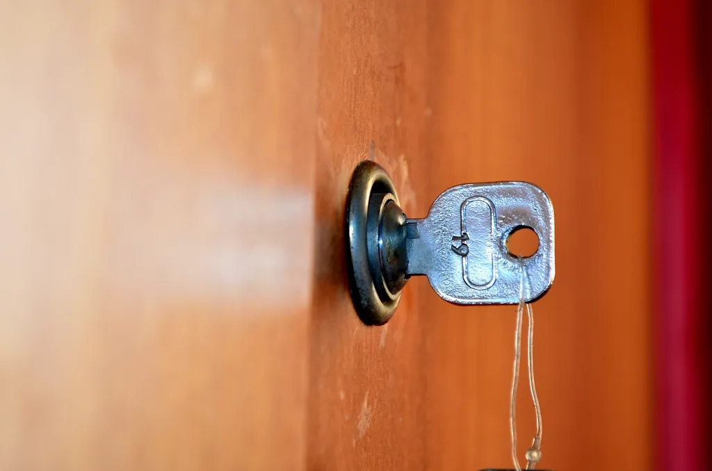 Key turning in a lock on a wooden door, checking requests before they get inside