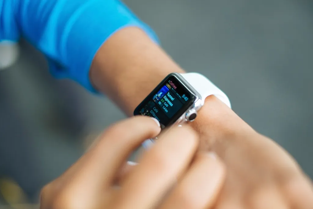 Person checking stats on a smartwatch, letting real usage data guide upgrade timing