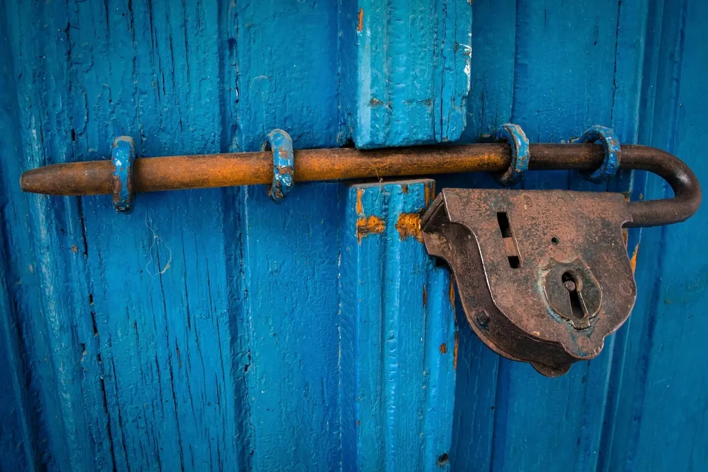 Bolt lock on a blue wooden door, one of several layers of protection