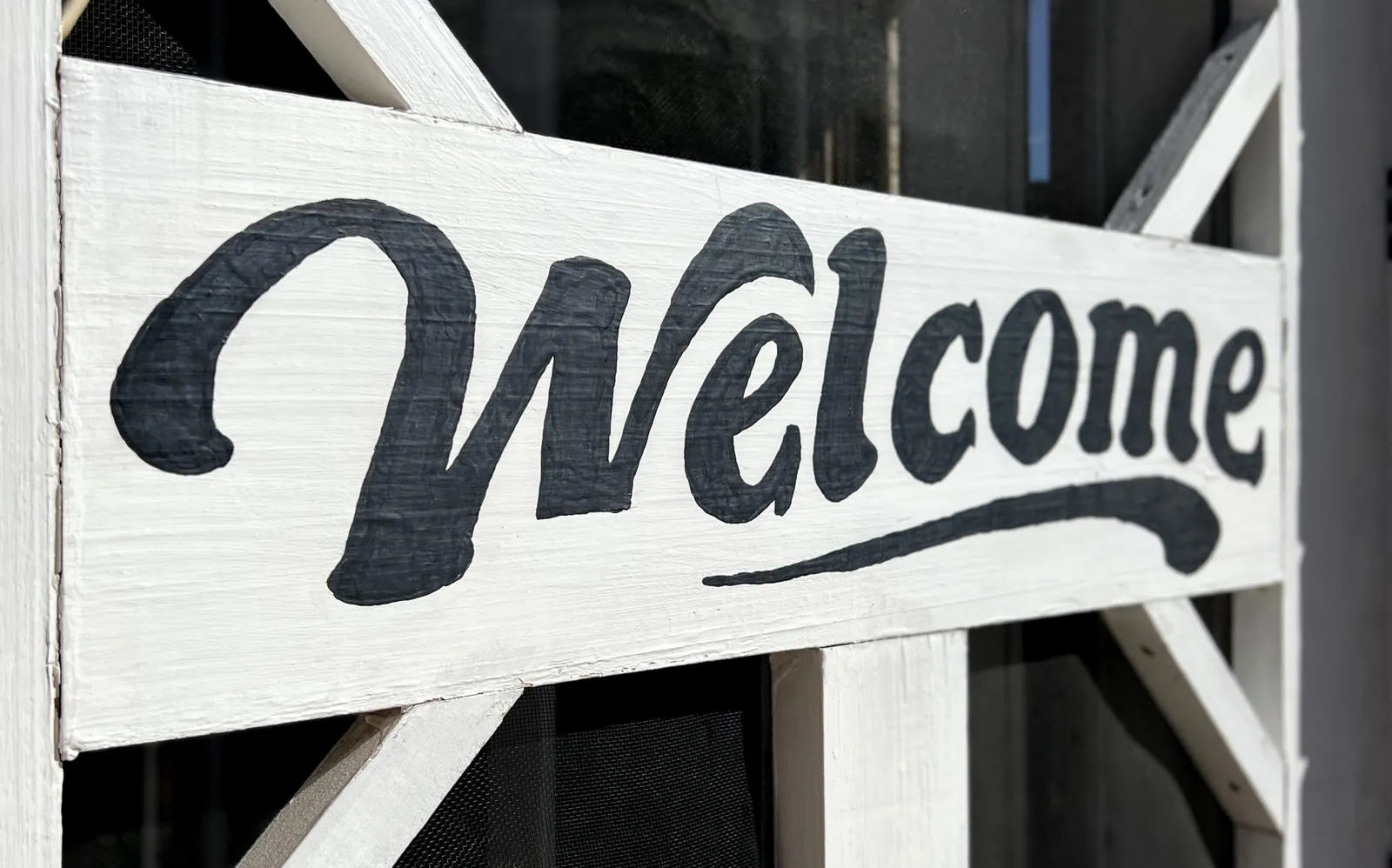 Hand painted welcome sign, a reminder that most steady work arrives through warm introductions