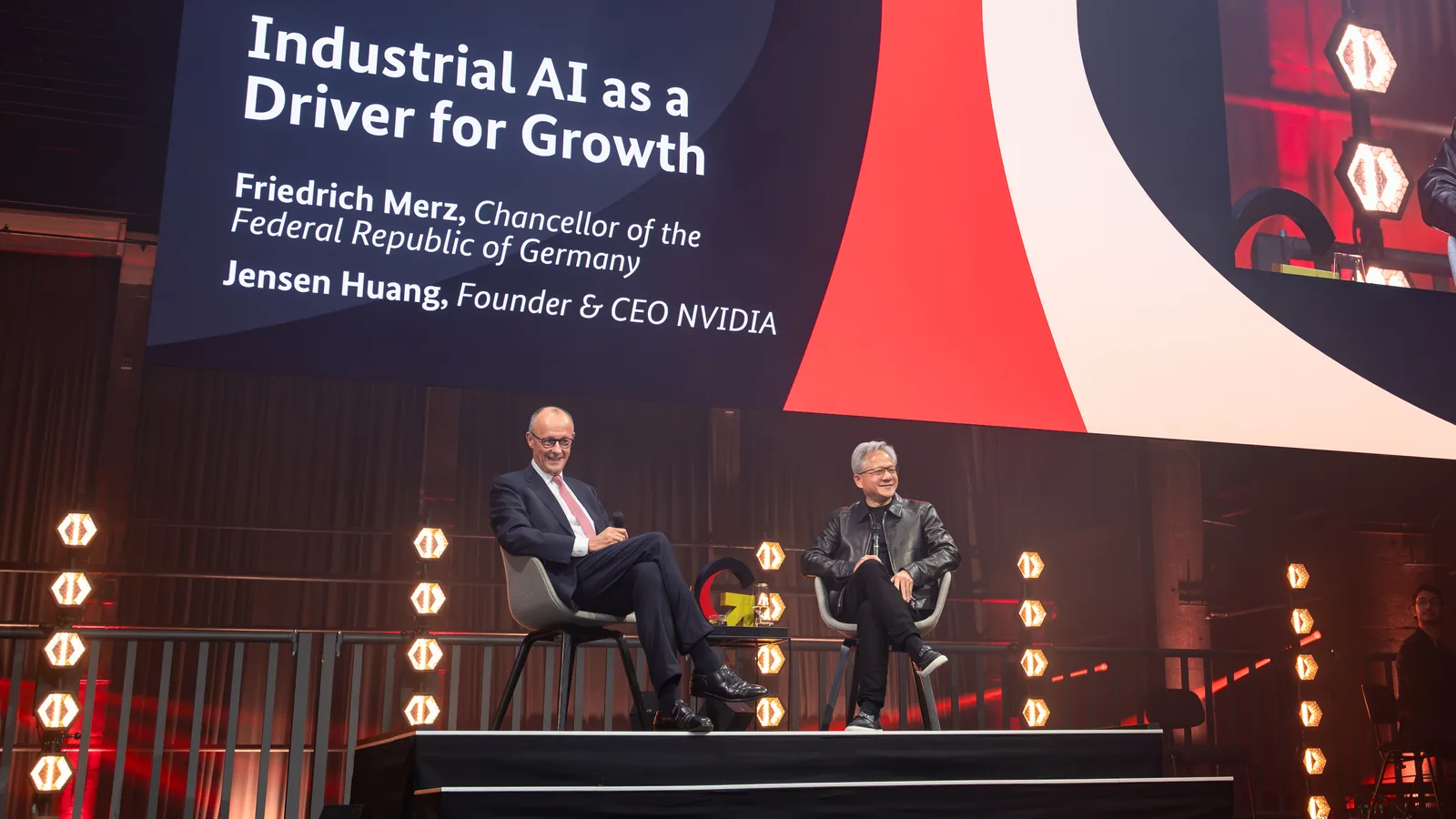 Chancellor Friedrich Merz and Jensen Huang on stage under a screen reading Industrial AI as a Driver for Growth